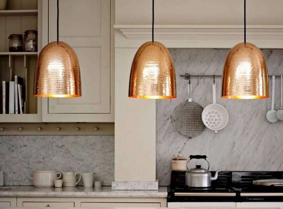 Hammered copper pendant lights over kitchen island
